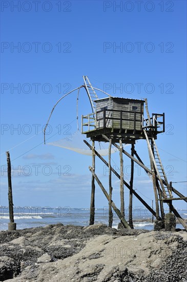 Traditional carrelet fishing hut with lift net on the beach at Saint-Michel-Chef-Chef