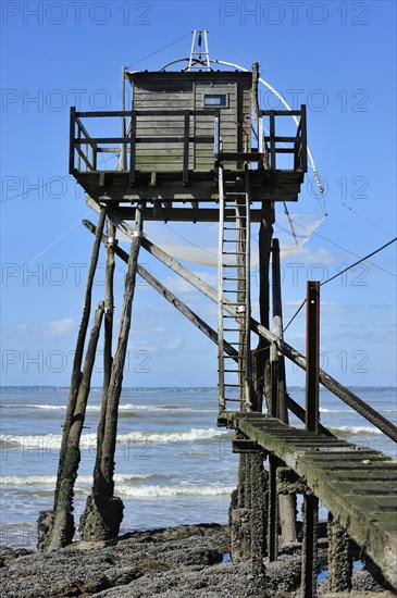 Traditional carrelet fishing hut with lift net on the beach at Saint-Michel-Chef-Chef