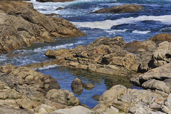 Old fish trap between the rocks on the shore at Saint-Guenole