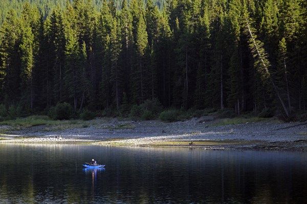 Angler in blue inflatable pontoon fishing boat at Lower Kananaskis Lake