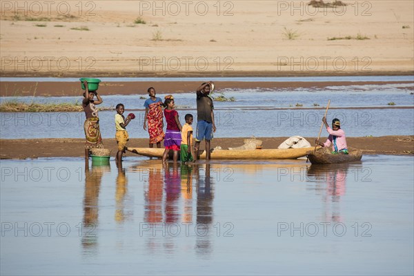 Malagasy fisherman selling fish along the Tsiribihina