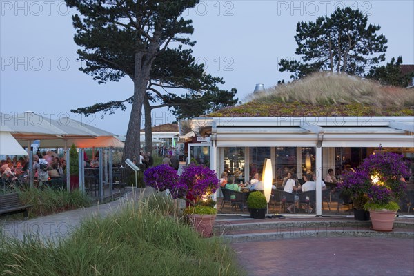 Tourists in cafe at seaside resort Scharbeutz