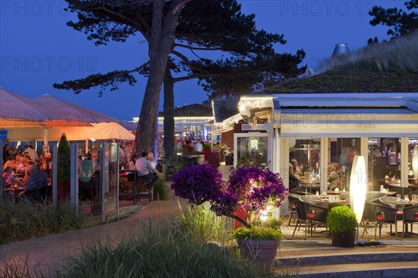 Tourists in cafe at seaside resort Scharbeutz at night