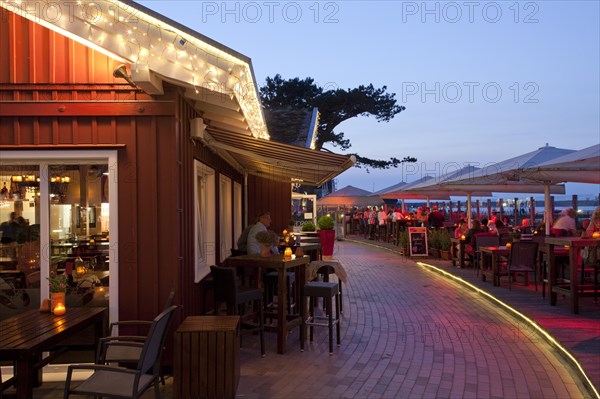 Tourists in cafe at seaside resort Scharbeutz