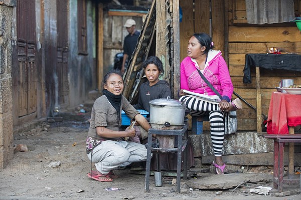 Malagasy women cooking food in street restaurant in the city Antsirabe