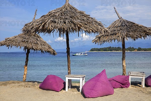 Parasols of beach restaurant on the island Gili Trawangan