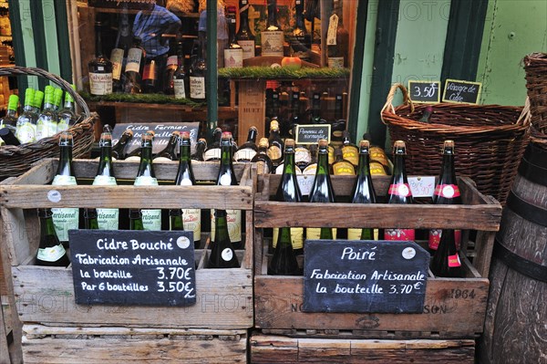 Regional products like cider and bottles of calvados in shop at Honfleur