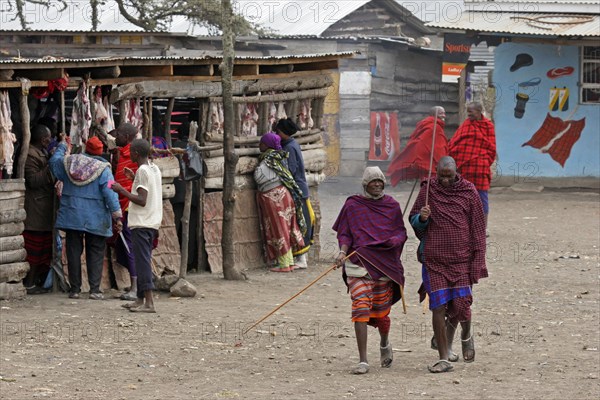 Maasai men walking in the street in village