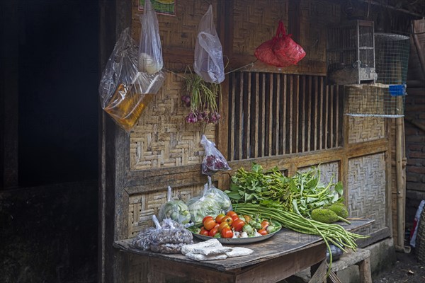 Food for sale in front of traditional bamboo house in the village Sade