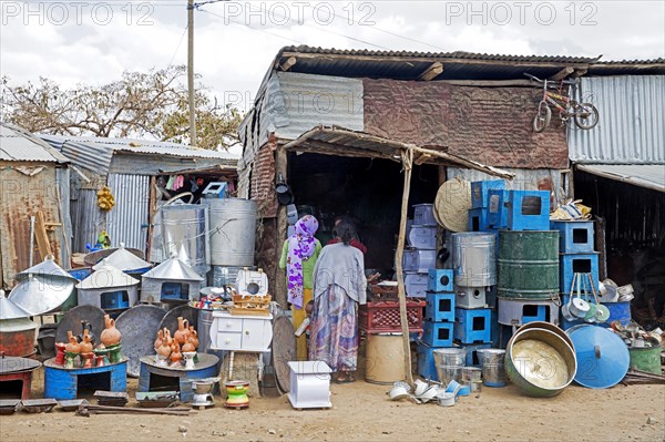 Local women shopping at little hardware store in the town Axum