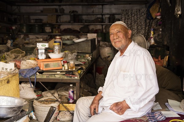 Arab vendor in his shop in the city Kashgar