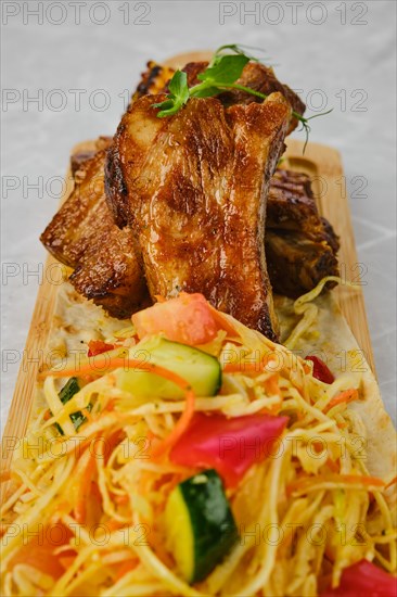 Grilled beef ribs served with garnish