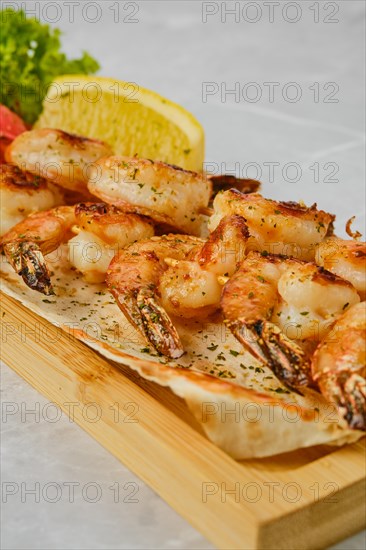 Grilled spicy shrimps on wooden skewer