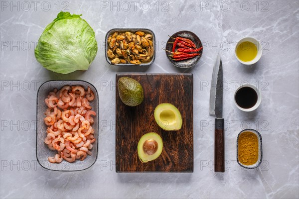 Overhead view of ingredients for shrimp salad with mussel and avocado