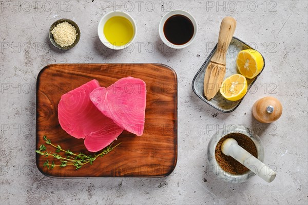 Top view of raw ahi tuna steak on cutting board with spice