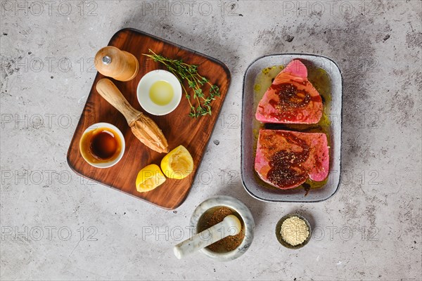 Top view of marinated with spice and herbs ahi tuna steak in a bowl