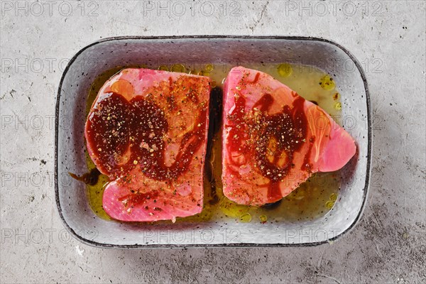 Top view of a bowl with marinated with spice and lemon juice ahi tuna steak