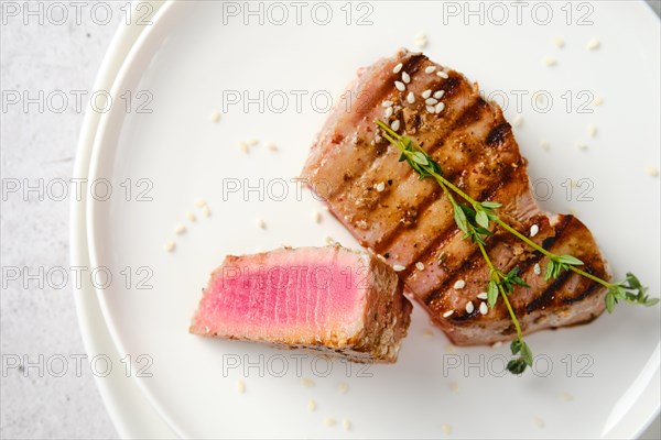 Closeup top view of plate with a portion of grilled tuna steak