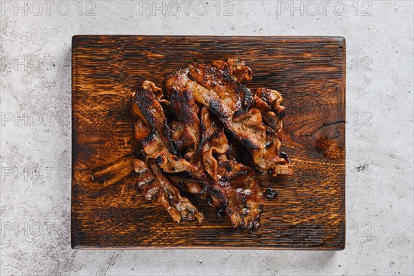 Top view of serving board with fried beef bacon strips