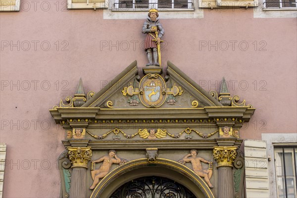Elaborate detail of the entrance door with figures on the facade
