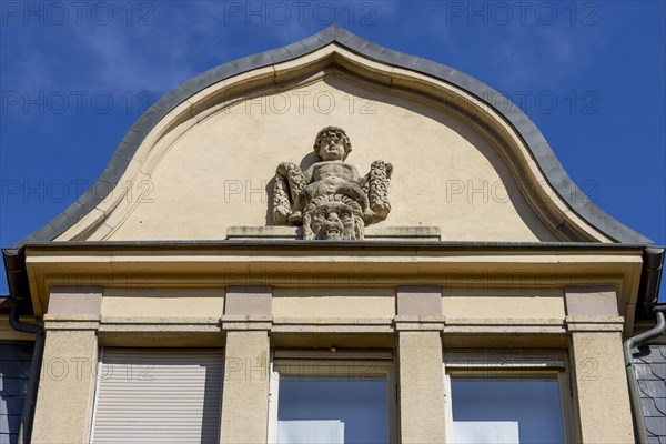 Gabled house with a facade sculpture of a boy in the historic city centre