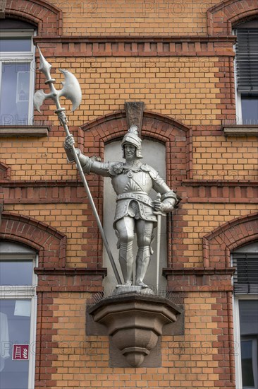 Knightly sculpture on the red brick facade of a building in Bahnhofstrasse