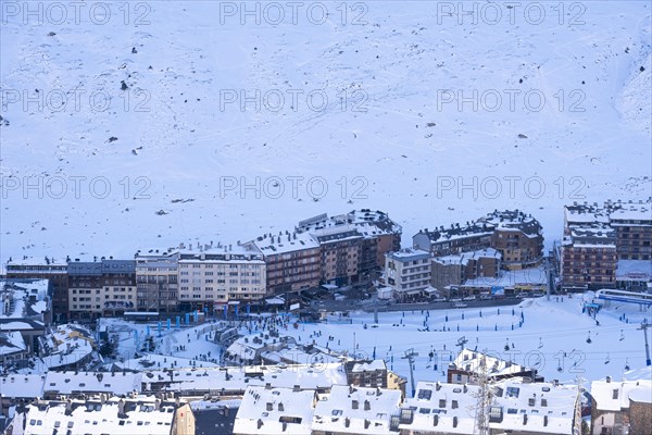 Aerial view of El Pas de la Casa in the snowy landscape in the Pyrenees mountains in Andorra