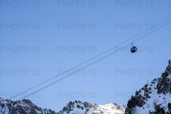Winter journey unfolds cable car amid Andorra's snowy peaks alpine wonder