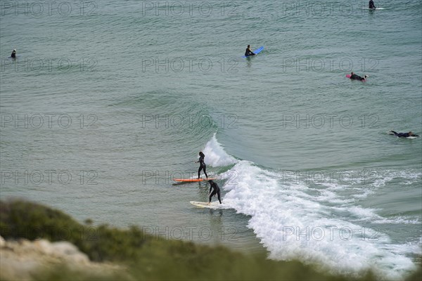 Surfers in the surf at Sagres beach