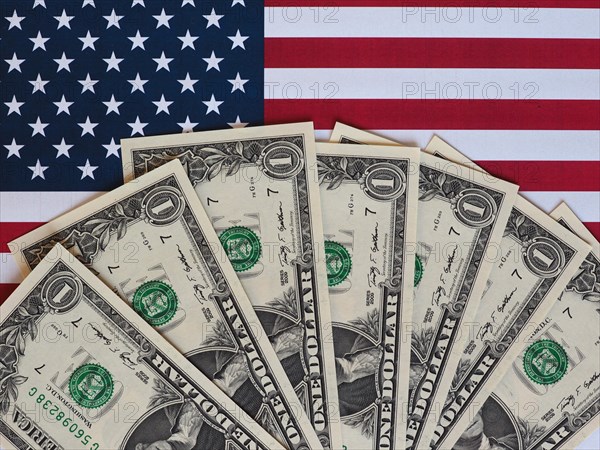 Dollar notes and flag of the United States