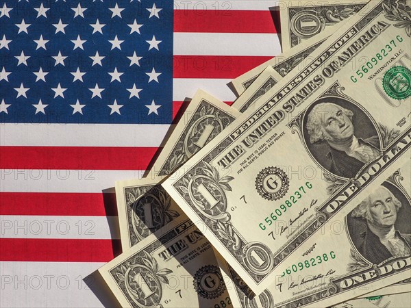 Dollar notes and flag of the United States