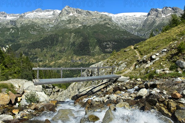 Bridge over the mountain stream Naestbach on the way to the Bietschhornhuette of the Akademischer Alpenclub Bern AACB