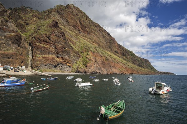 Boat harbour with boats and cliffs