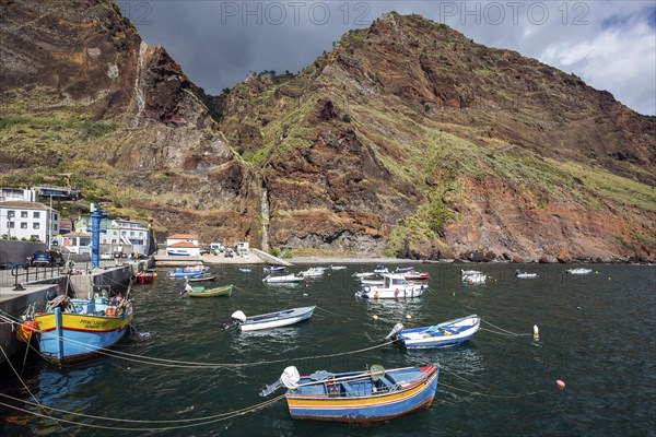 Boat harbour with boats and cliffs