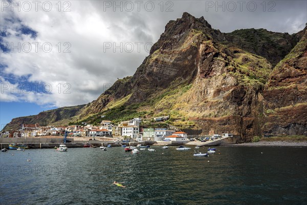 Boat harbour with boats and cliffs