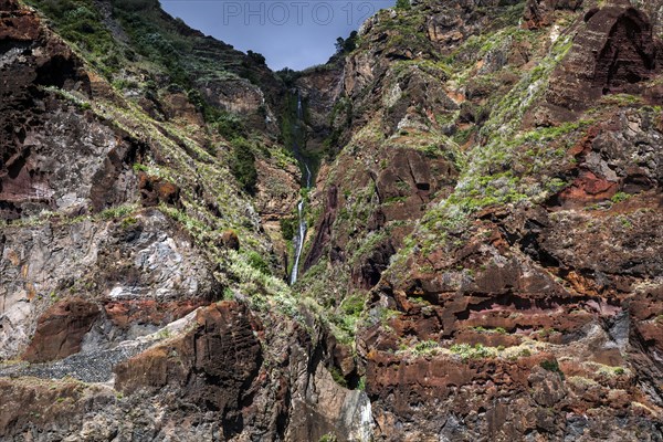 Volcanic cliff with waterfall