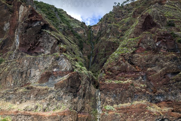 Volcanic cliff with waterfall