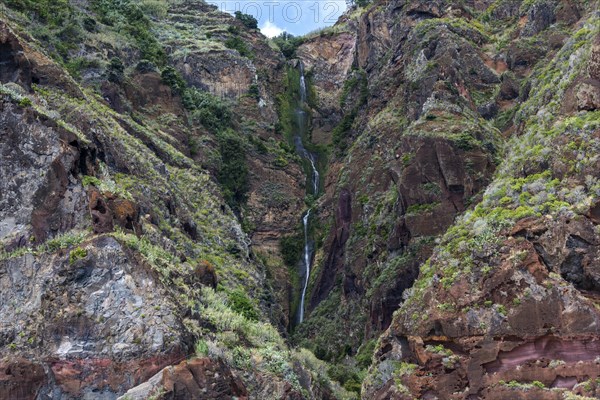 Volcanic cliff with waterfall