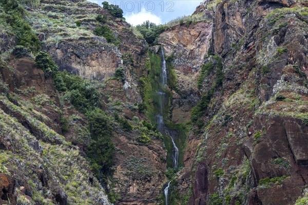 Volcanic cliff with waterfall