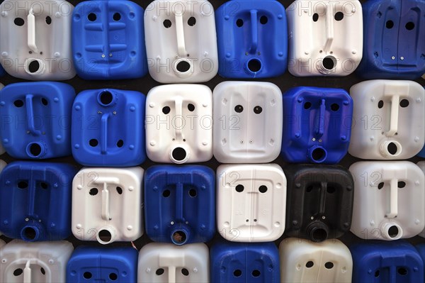 White and blue plastic canisters with faces