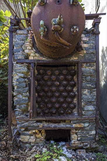 Rusted pressure vessel on a disused factory site