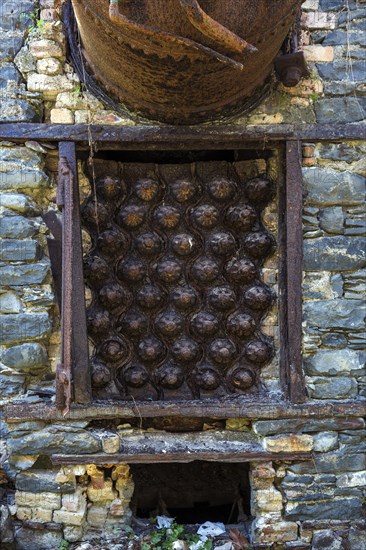 Rusted pressure vessel and bolts on a disused factory site