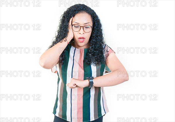 Surprised afro young woman looking at wrist watch. Worried afro girl looking at her watch isolated