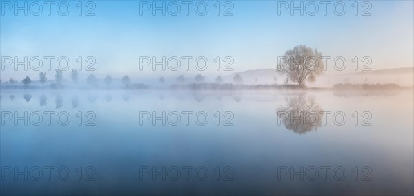 Lake with morning mist at dusk