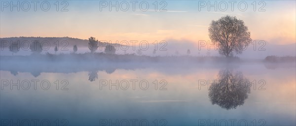 Lake with morning mist at dusk