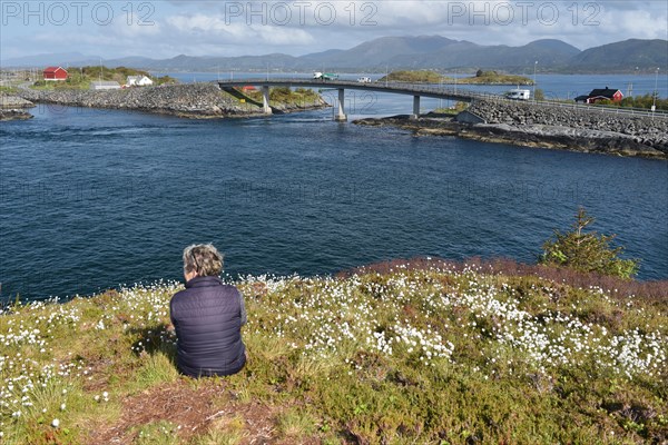 Woman sitting on the Atlantic Road in Norway