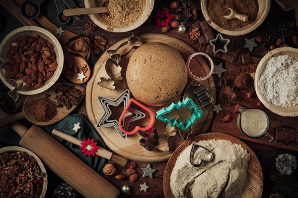 Dough ball and cookie cutters on a wooden board