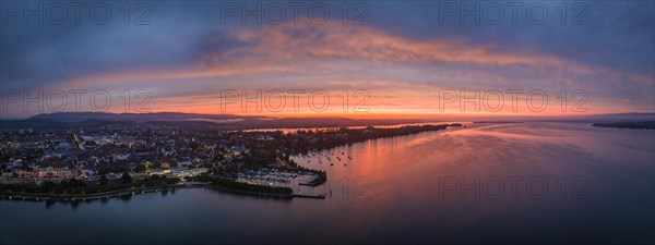 Aerial panorama of western Lake Constance in front of sunrise with the town of Radolfzell and the Mettnau peninsula