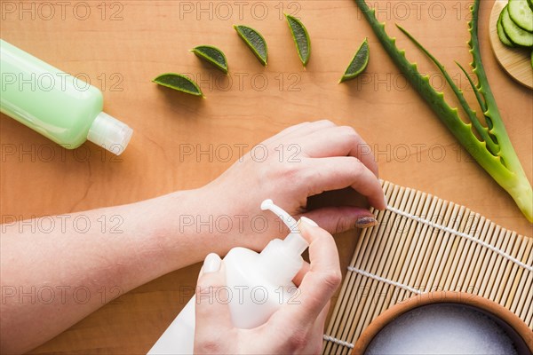 Hands applying aloe vera cream