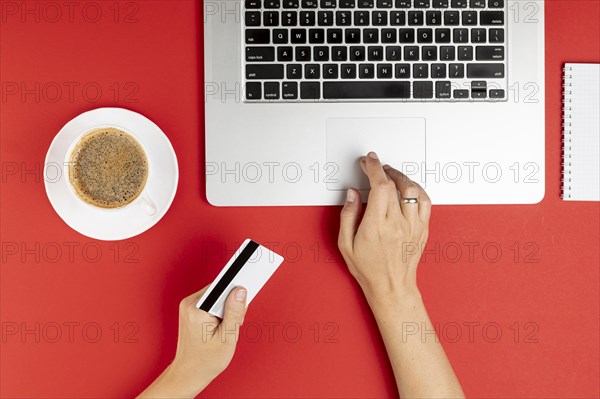 Hands using computer holding card